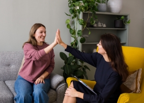 Woman high fiving a dental team member