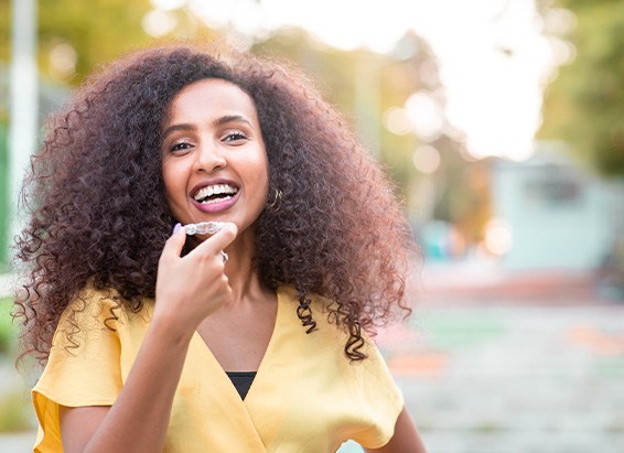 Patient smiling with clear Invisalign trays