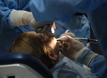 Dentist performing surgery