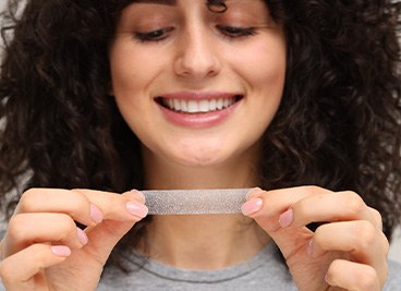 Woman using a whitening strip