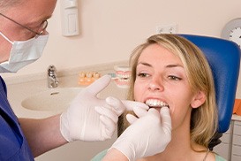 Patient getting new Invisalign trays at dental appointment