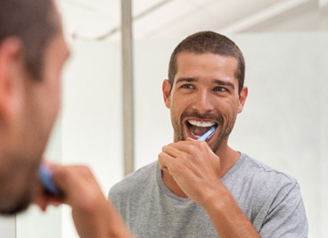 Dental implants patient in York brushing their teeth