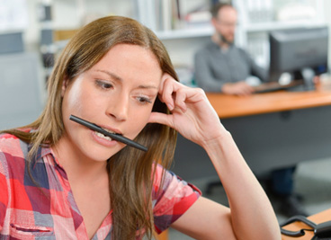 Dental implants patient in York biting a pen