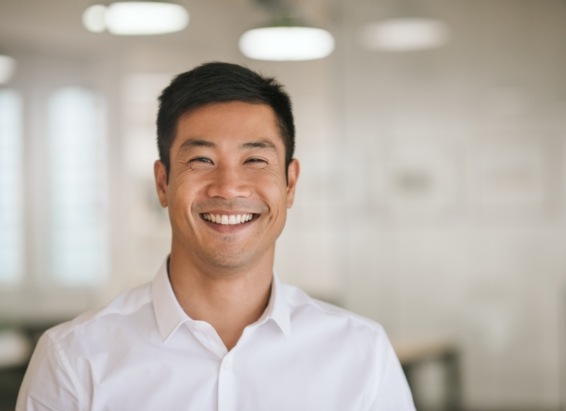 Man in white dress shirt smiling after restorative dentistry in York