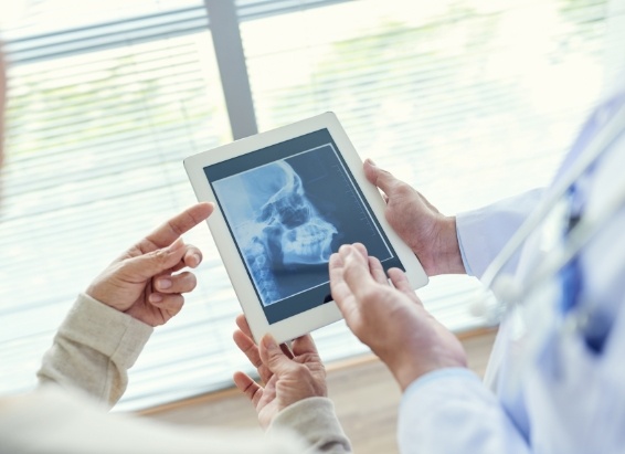 Dentist showing a patient x rays of their teeth during preventive dentistry visit