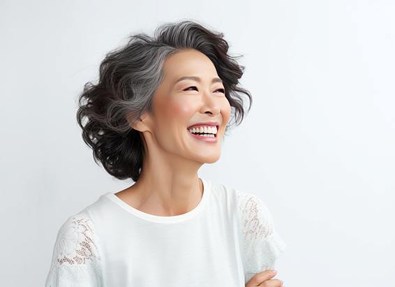 Woman smiling after receiving dental crown