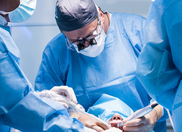 Dentists performing a dental implant surgery