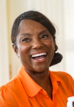Smiling older woman in orange button up blouse