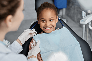 Child smiling at the dentist