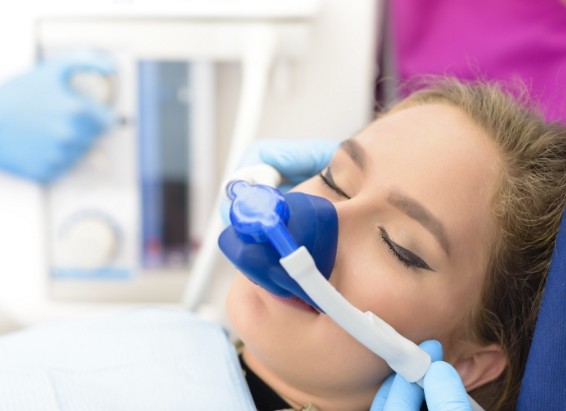 Dental patient wearing mask for nitrous oxide sedation dentistry