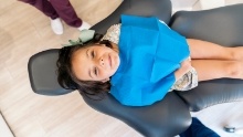 Child smiling in dental chair