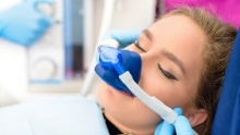 Woman in dental chair wearing nitrous oxide sedation dentistry mask