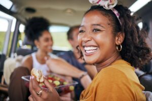 Woman smiling and eating with dental implants