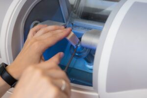 Dentist putting ceramic block in CEREC milling machine